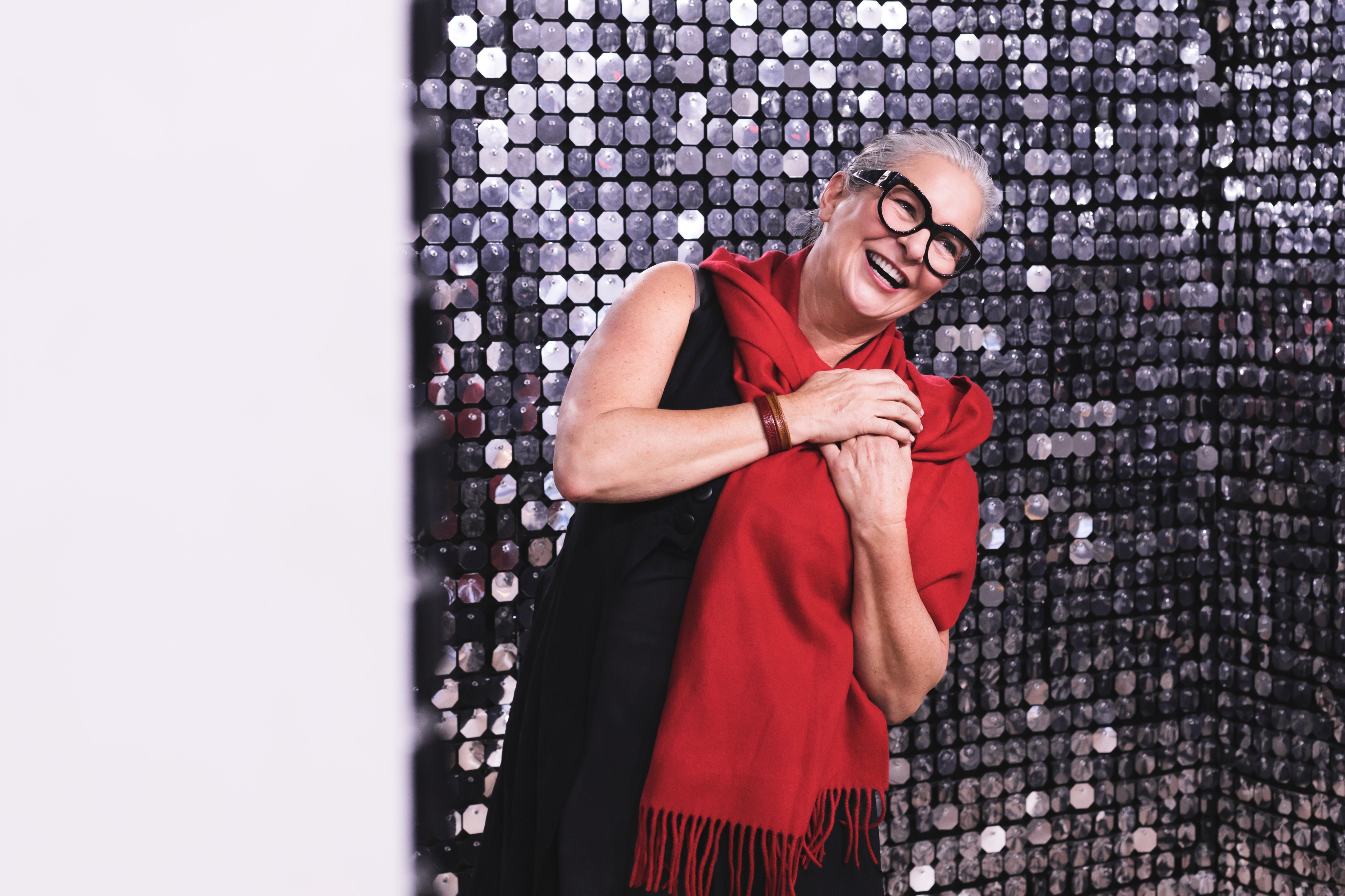 files/women-smiling-in-front-of-silver-background.jpg